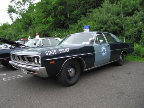 1991 Ford LTD Crown Victoria - dark-green and white late-1960s Dodge full-size 'STATE POLICE' sedan with a blue dome light, at a show.