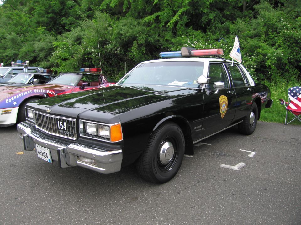 Black Connecticut State Police sedan with light bar and number 154