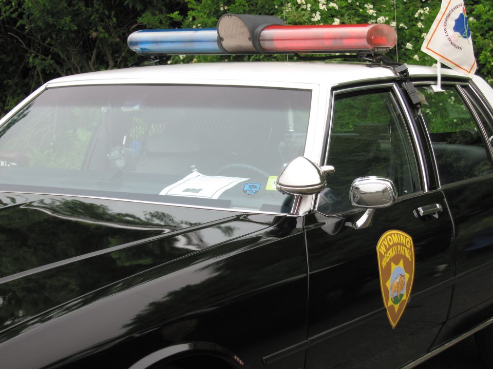 Close-up of a black-and-white police car roof light bar and door shield