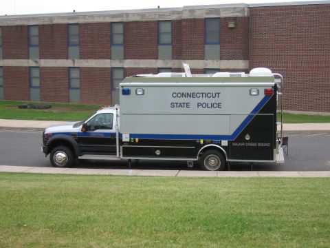 1991 Ford LTD Crown Victoria - Connecticut State Police Major Crime Squad box truck command vehicle parked on a road in front of a brick building.