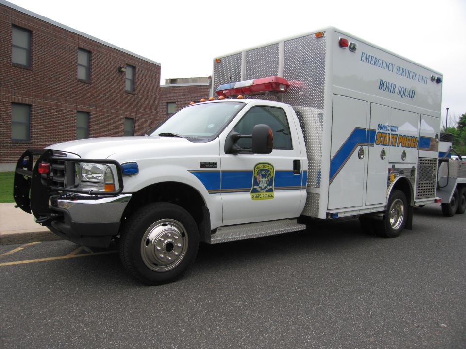 White Ford F-series State Police Bomb Squad truck with box body and brush guard