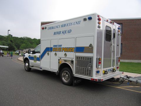 1991 Ford LTD Crown Victoria - Rear three-quarter view of a white Connecticut State Police Emergency Services Unit Bomb Squad box truck towing a trailer in a paved lot.
