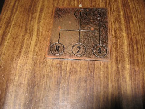 1968 Shelby GT500 - This is a shift pattern plate for a 4-speed manual transmission, showing the positions for Reverse, 1st, 2nd, 3rd, and 4th gears.