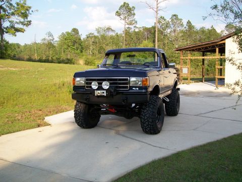 1990 Ford Bronco - Modified 1990 Ford Bronco with large off-road tires and a custom front bumper.