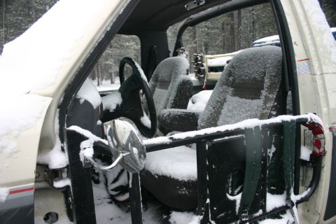 1991 Ford Bronco - The interior of a 1991 Ford Bronco is covered in snow, suggesting it has been parked outdoors in winter conditions.
