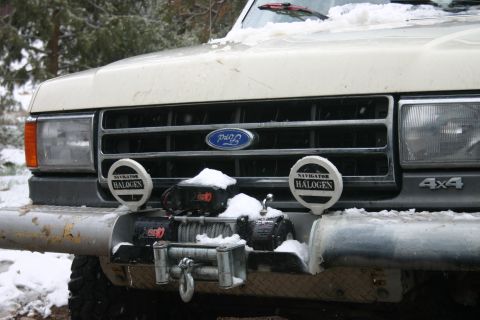 1991 Ford Bronco - This Ford Bronco is equipped with a winch and auxiliary halogen lights, seen in a snowy environment.