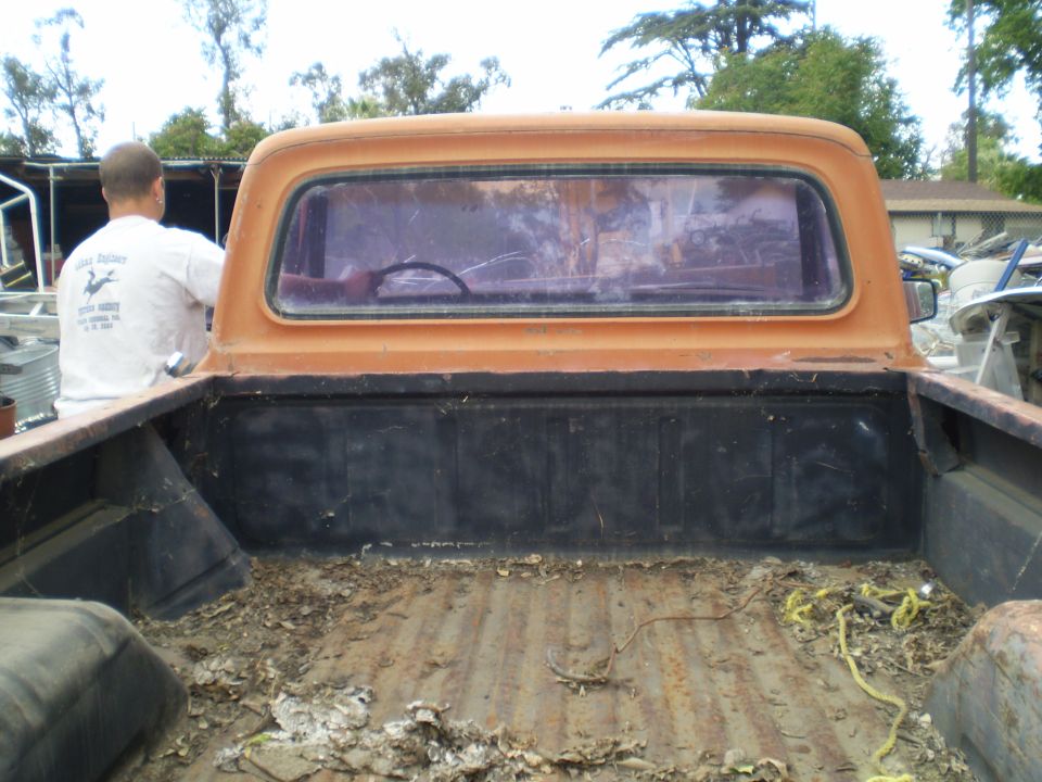 Orange 1969 Ford F-250 rear view showing bed and cab