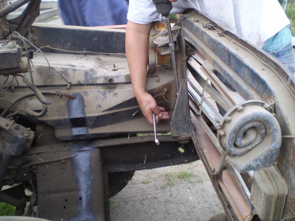 Person using a wrench on the grille of a 1969 Ford F-250