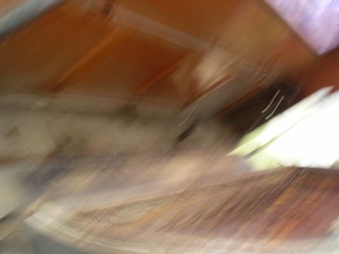 1969 Ford F-250 - The interior of a vehicle is captured in a blurry photograph, showing brown and tan surfaces and a Supermotors watermark.