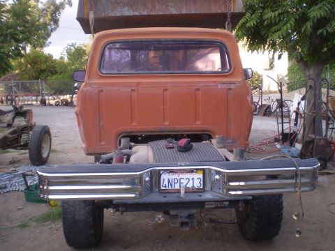 1969 Ford F-250 - This truck's rear end is visible, showing its bumper, license plate, and part of the bed.