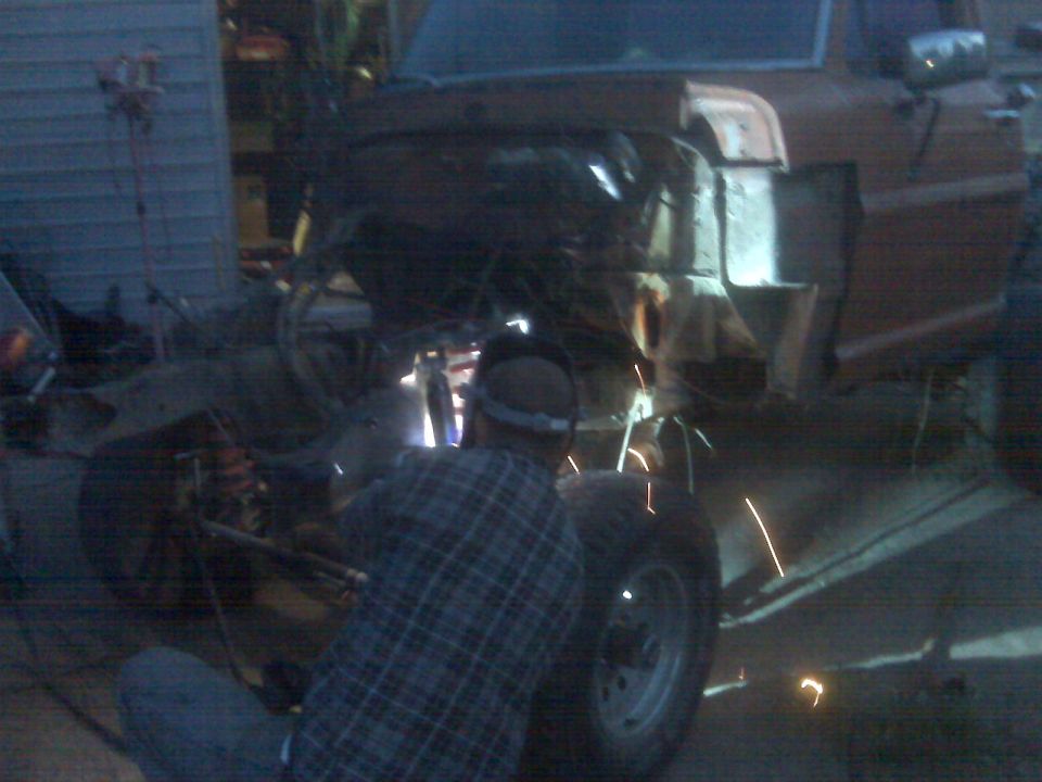 1969 Ford F-250 frame being welded, front wheel visible