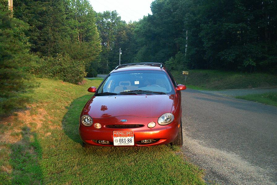 1996 Ford Taurus front view, parked on grass next to a road