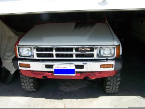 1988 Suzuki Samurai - This Toyota pickup truck, likely from the mid-1980s, is parked inside a garage.