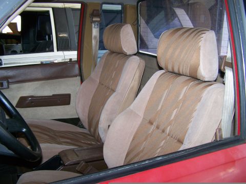 1988 Suzuki Samurai - The interior features striped seats and a visible watermark from Supermotors.net.