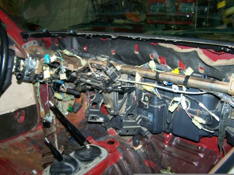 1988 Suzuki Samurai - The interior of a 1988 Suzuki Samurai is shown with the dashboard disassembled, revealing its internal components and wiring.