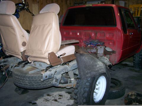 1988 Suzuki Samurai - This vehicle appears to be undergoing repairs or modifications, with its front end disassembled and interior components exposed.