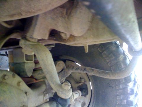 1995 Ford Bronco - A close-up view of the undercarriage reveals suspension parts and a tire, with a Supermotors.net watermark.