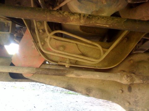 1995 Ford Bronco - Underside view of vehicle's brake lines and frame components.