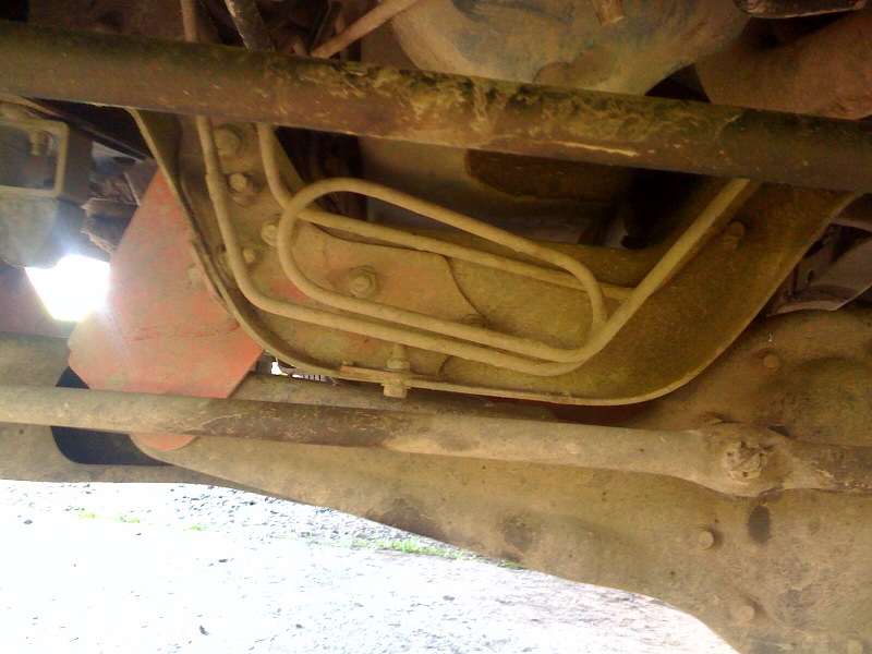 Close-up of brake lines and suspension components on a vehicle's underbody