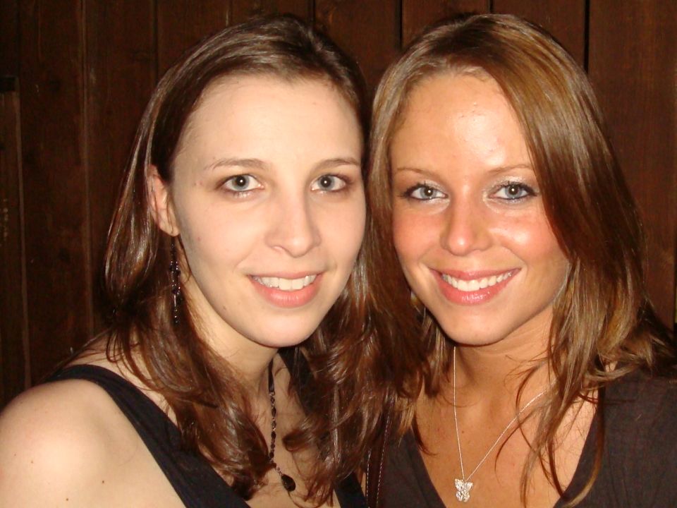 Two women smiling for a photo. A watermark at the bottom says SUPERMOTORS.NET
