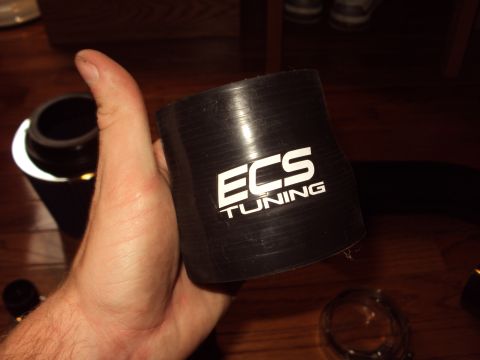 1993 Ford Probe - A black silicone hose with the ECS Tuning logo is held by a person's hand.