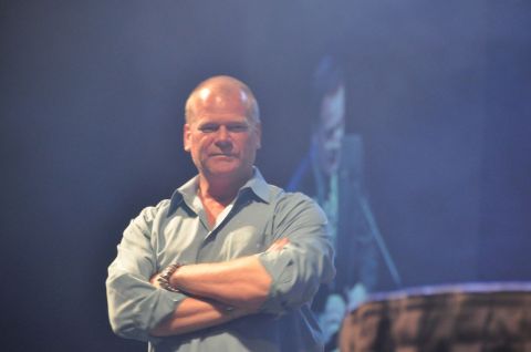 1996 Ford Bronco - Mike Holmes stands with his arms crossed in front of a blurred background.