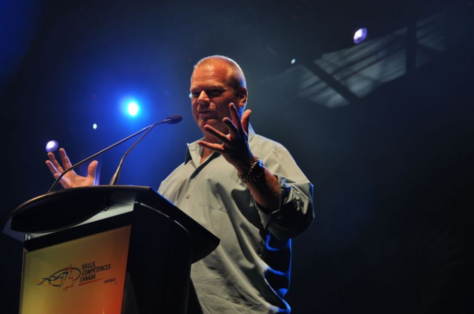 Man speaking at a podium with 'Skills Competences Canada' logo