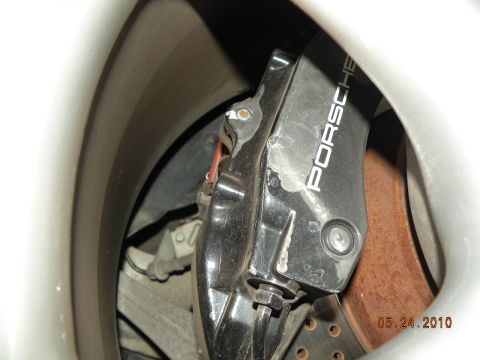 2000 Porsche Carrera - Close-up of a Porsche brake caliper and rotor assembly, showing the brand name on the caliper.