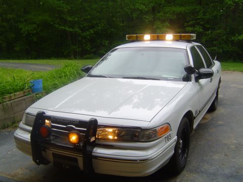 1994 Ford Crown Victoria - This 1994 Ford Crown Victoria police car is parked outside with a light bar on the roof.