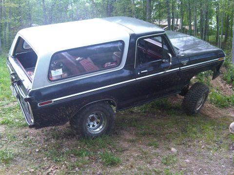 1979 Ford Bronco - This 1979 Ford Bronco is shown in a three-quarter front view, a black body with a silver removable top.