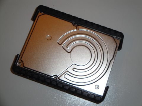 1993 Ford Taurus - A computer hard drive with a metallic finish and protective rubberized edges is shown from above.