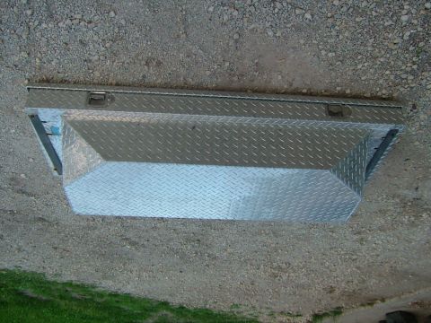 1991 Toyota Tacoma - A diamond plate truck bed tool box with two latches is shown on a gravel surface.