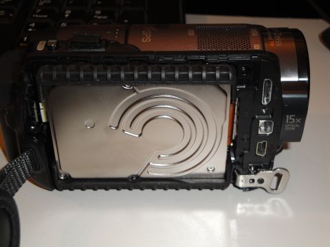 1993 Ford Taurus - A camcorder's internal hard drive is visible after removing the side panel, revealing various ports and markings.