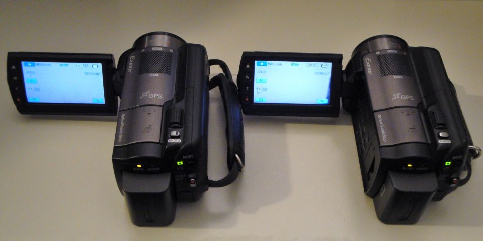 Two camcorders with screens open, showing menus