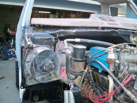 1985 Ford Bronco - The engine bay of a vehicle undergoing restoration, revealing the engine and associated components.