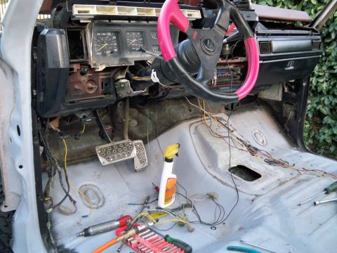 1985 Ford Bronco - Interior of a 1985 Ford Bronco undergoing restoration, with dashboard and wiring exposed.