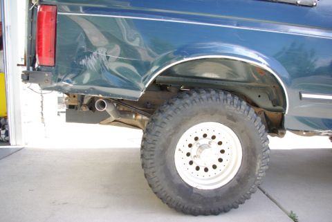 1995 Ford Bronco - The rear quarter panel of the SUV shows significant damage, with the exhaust pipe visible underneath.