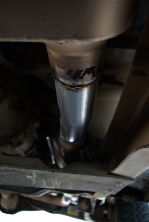 1995 Ford Bronco - Exhaust pipe section with visible weld marks and some unidentifiable black lettering.