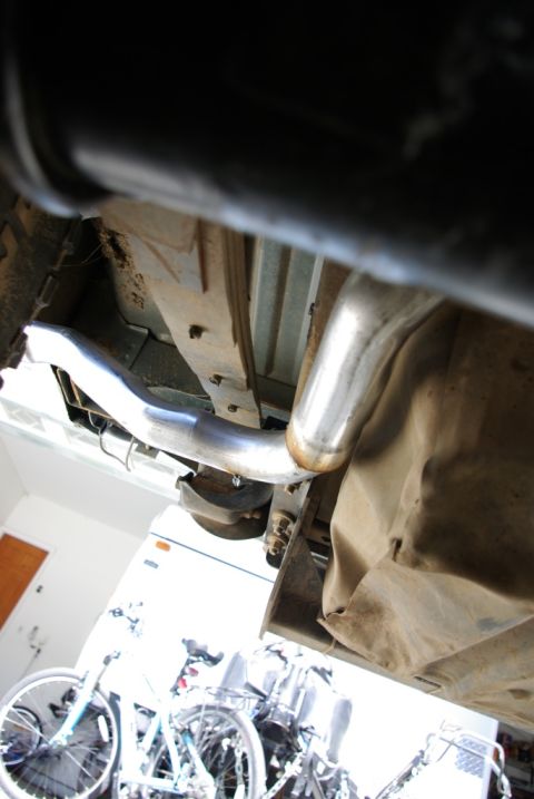1995 Ford Bronco - The photo shows the underside of a vehicle, focusing on the exhaust system and suspension components.