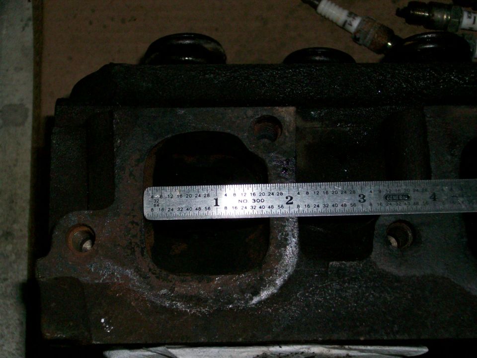 Steel ruler measuring the intake port on a used cast iron cylinder head