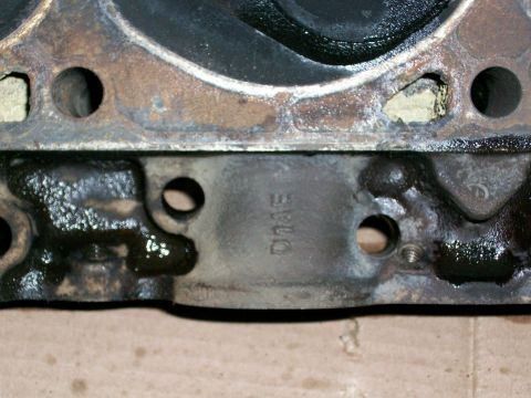 1973 Ford Ranchero - Close-up of an engine cylinder head, showing cast markings and oil. The registry claim of a 1973 Ford Ranchero is not supported by this ima…