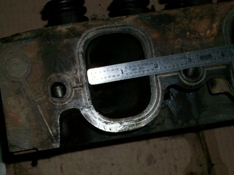 1973 Ford Ranchero - A ruler measures the port opening on a used engine cylinder head, likely for an automotive part sale.