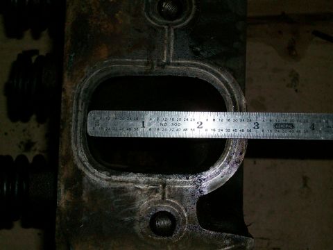 1973 Ford Ranchero - A ruler measures the bore of an engine cylinder head, likely for a Ford vehicle.