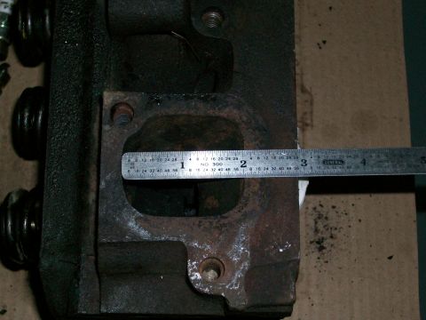 1973 Ford Ranchero - A close-up view of an engine cylinder head, with a ruler measuring the exhaust port opening.