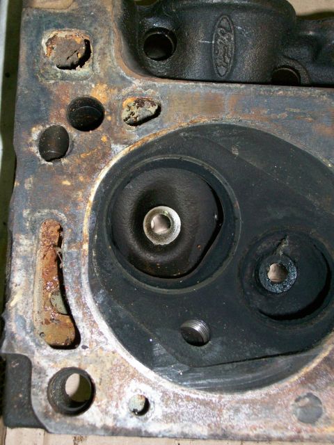 1973 Ford Ranchero - Close-up of a Ford engine cylinder head, showing the Ford oval logo and combustion chamber details.