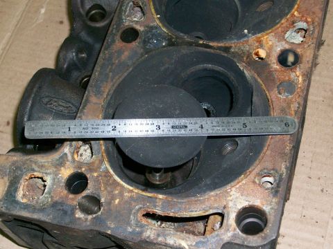 1973 Ford Ranchero - A ruler is placed across the combustion chamber of a worn engine cylinder head.