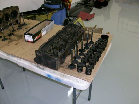 1973 Ford Ranchero - Engine cylinder heads and valves are laid out on a table, suggesting a repair or rebuild.