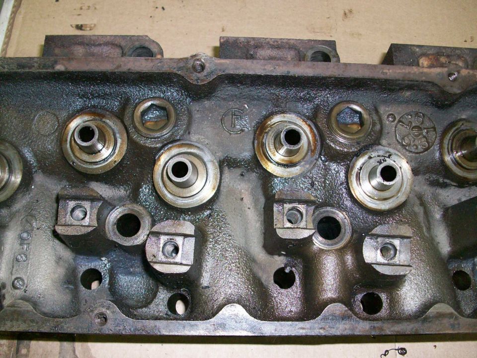 Engine cylinder head with visible valve seats and rocker arm studs