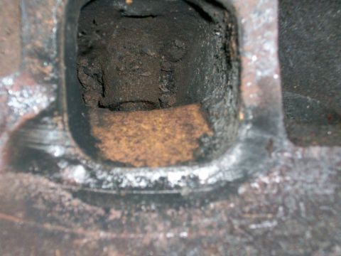 1973 Ford Ranchero - Engine cylinder head port showing significant carbon buildup and rust.