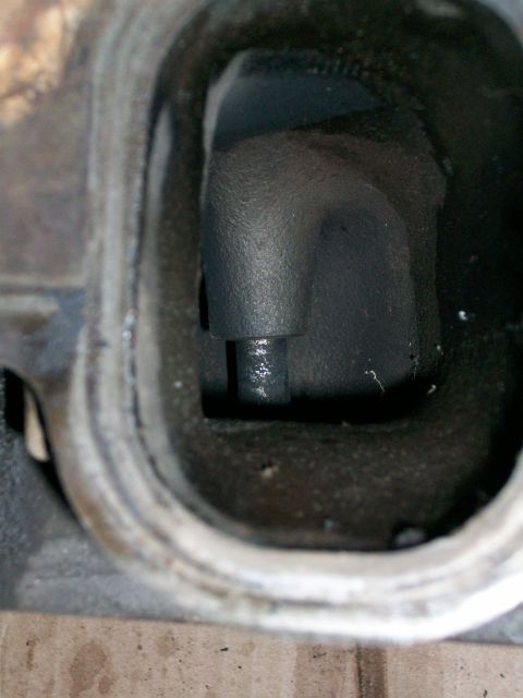 1973 Ford Ranchero - Interior view of an engine cylinder head port with a valve stem visible.